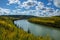 Brilliant autumn forest colors line the powerful Liard River