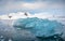 Brilliant blue iceberg floating in Antarctica waters