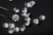 Brilliant cut diamond held by tweezers on black background