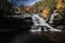 Brilliant fall foliage surrounds the beautiful cascading Shohola Falls in the Pennsylvania Poconos