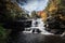 Brilliant fall foliage surrounds the beautiful cascading Shohola Falls in the Pennsylvania Poconos