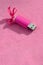 Brilliant pink usb flash memory card with a pink bow lies on a blanket of soft and furry light pink fleece fabric. Classic female