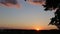 Brilliant summit dawn above flowing cloud waves, red sun disk time lapse