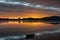 brilliant sunrise provides a glow and reflections across Tauranga Harbor.