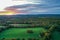 Brilliant Sunset in early fall over Sussex County NJ with large fields and foliage aerial