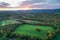 Brilliant Sunset in early fall over Sussex County NJ with large fields and foliage aerial