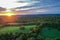 Brilliant Sunset in early fall over Sussex County NJ with large fields and foliage aerial