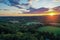 Brilliant Sunset in early fall over Sussex County NJ with large fields and foliage aerial