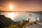 Brilliant sunset at Fira with a church and a bride on a roof, Santorini,