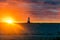 Brilliant Sunset Over Lake Behind Lighthouse