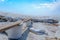 Brine salt farm with blue sky and white clouds. Pile of organic sea salt near warehouse. Raw material of salt industrial. Ocean