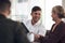 Bringing his part to his committed team. a young businessman having a discussion with his colleagues in an office.