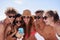 Bringing together a group of best friends. a group of friends taking selfies on the beach.