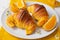 Brioche croissants on a plate with oranges