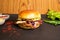 Brioche Smash Double Beef Cheese Burger with tomato sauce and green chilli isolated on table side view of fastfood