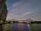 BRISBANE, AUSTRALIA - JULY 10, 2020: Twilight scene of famous Story Bridge and City Cat ferry in Brisbane River with high-rise