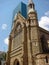 Brisbane cathedral overlapping a modern glass skyscraper