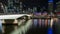 Brisbane Victoria Bridge iluminated against dark and city building lights