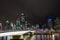 Brisbane Victoria Bridge iluminated against dark and city building lights