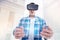 Bristled man looking at transparent tablet through VR headset