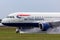 British Airways Airbus A318-112 aircraft G-EUNB landing on the wet runway with reverse thrust spraying water