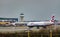 A British Airways plane taxis after landing at London Gatwick Airport, with the air traffic control tower in the background