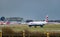 A British Airways plane taxis after landing at London Gatwick Airport, with airport builidngs in the background