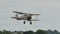 British biplane fighter propeller airplane of the 1930s lands on grass airfield