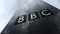 British Broadcasting Corporation BBC logo on a skyscraper facade reflecting clouds. Editorial 3D rendering