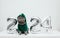 British cat in a green dragon costume on white background. Cat with Christmas decorations. Chinese New Year 2024 symbol. Copy