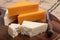 British cheeses collection, Scottish coloured and English matured cheddar cheeses close up