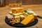 British drinks and food, glasses of Scotch whisky and cheeses collection, blue Stilton, Scottish coloured and English matured