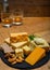 British drinks and food, glasses of Scotch whisky and cheeses collection, blue Stilton, Scottish coloured and English matured