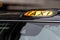 A british london black taxi cab sign with defocused  background