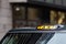 A british london black taxi cab sign with defocused  background