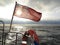 British maritime ensign flag boat and stormy sky