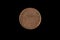 A British New Penny coin isolated on a black background