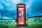 A british phone booth in the middle of the scottish countryside