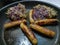 British pork sausages frying in hot oil