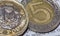 British Pound Coin on top of 5 Polish Zloty P