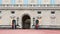 British Royal guards guard the entrance to Buckingham Palace, London, UK