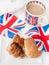 British sausage sandwich with, brown sauce, cup of tea and flag