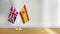 British and Spanish flag pair on a desk over defocused background