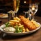 British Traditional Fish and chips with mashed peas, tartar sauce on wooden table