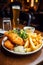 British Traditional Fish and chips with mashed peas, tartar sauce on wooden table