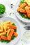 British Traditional Fish finger and chips with peas and tartar sauce in a white plate.