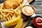 British traditional fish and potato chips on wooden table