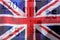British Union Jack flag blowing in the wind. UK flag colorful and background pound banknotes
