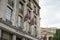 British Union Jack flags on flagpoles in front of a building in West London near Trafalgar Square.