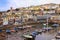 BRIXHAM, DEVON, UK, NOV 02 2015: Small boats moored at low tide in the fishing port, with the town of Brixham in the background